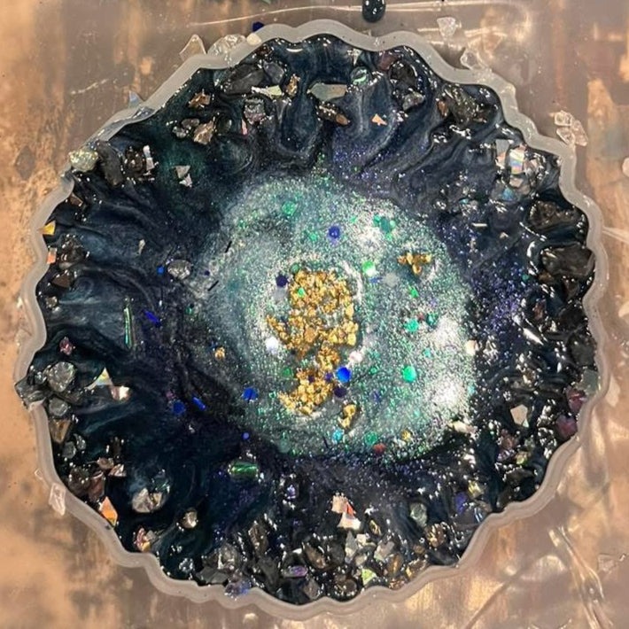 Decorative epoxy coaster with a blue and gold center.