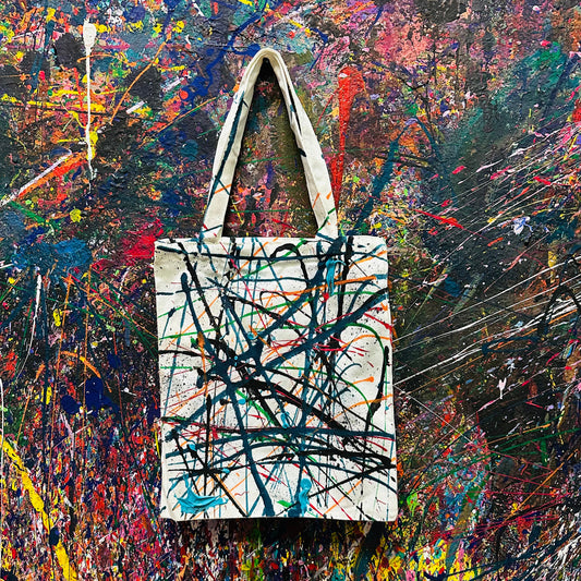 Tote bag with abstract design on a colorful abstract background