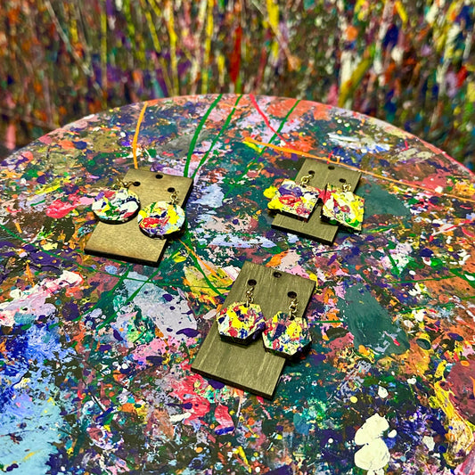 Colorful jewelry set on a splatter painted stool with abstract patterns