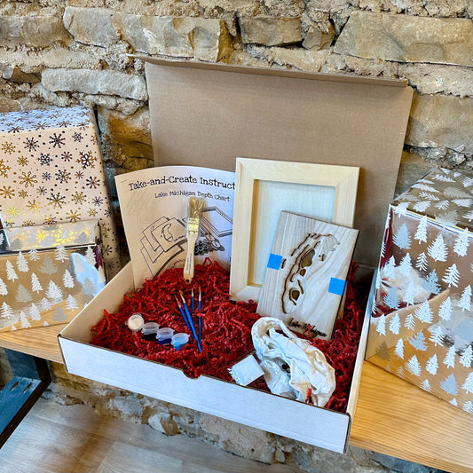Box containing wooden art supplies and instructions against a stone wall background