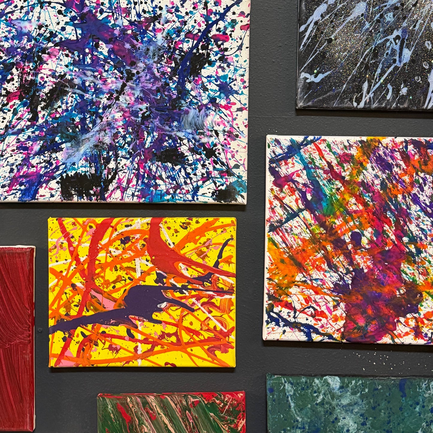 Collection of abstract splatter paintings on a black background