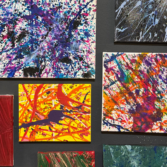 Collection of abstract splatter paintings on a black background