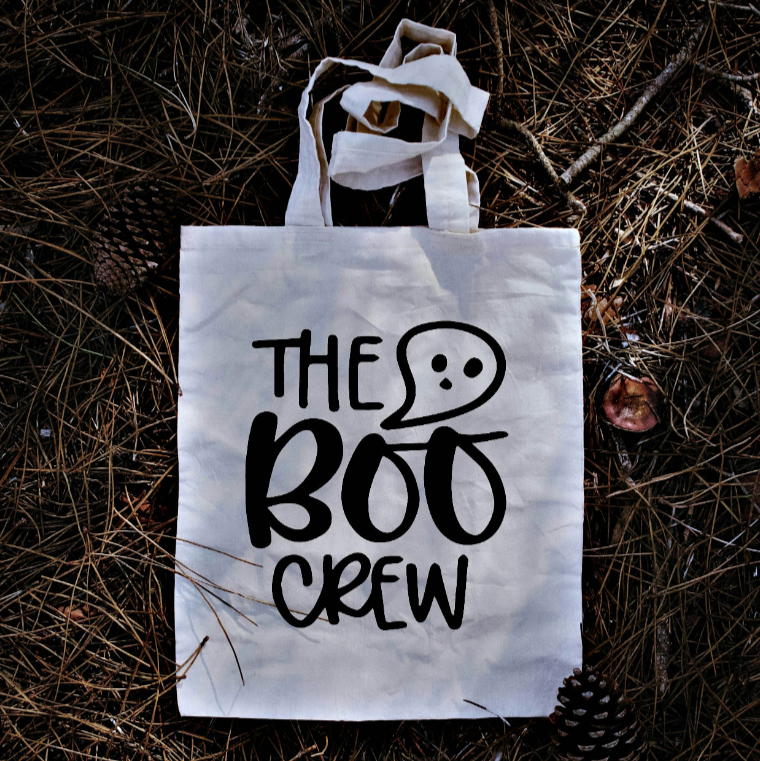 Tote bag with 'The Boo Crew' text on a forest floor background