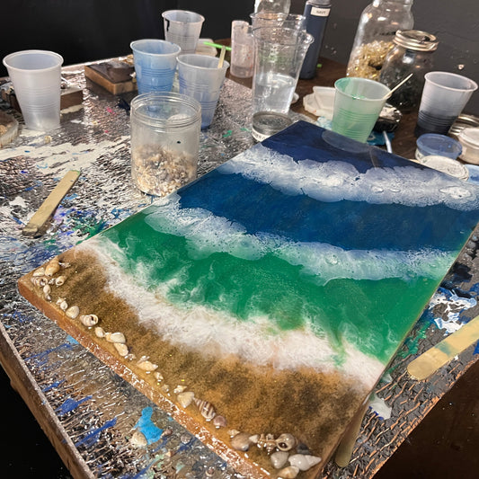 Artistic resin tray on a table with tools and materials