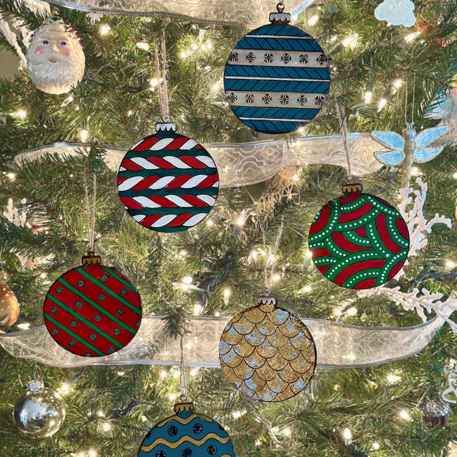 Wooden Christmas ornaments hanging on a Christmas tree.