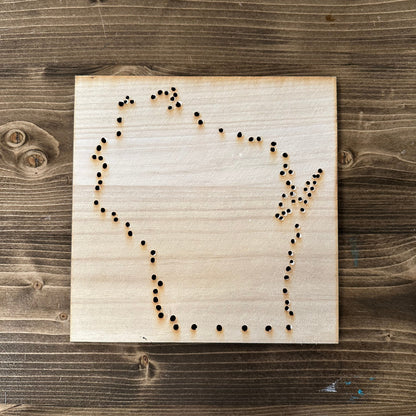 Wooden Wisconsin string art template design with drilled holes on a wooden background
