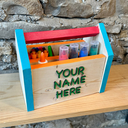 Wooden craft box with colorful compartments on a stone wall background