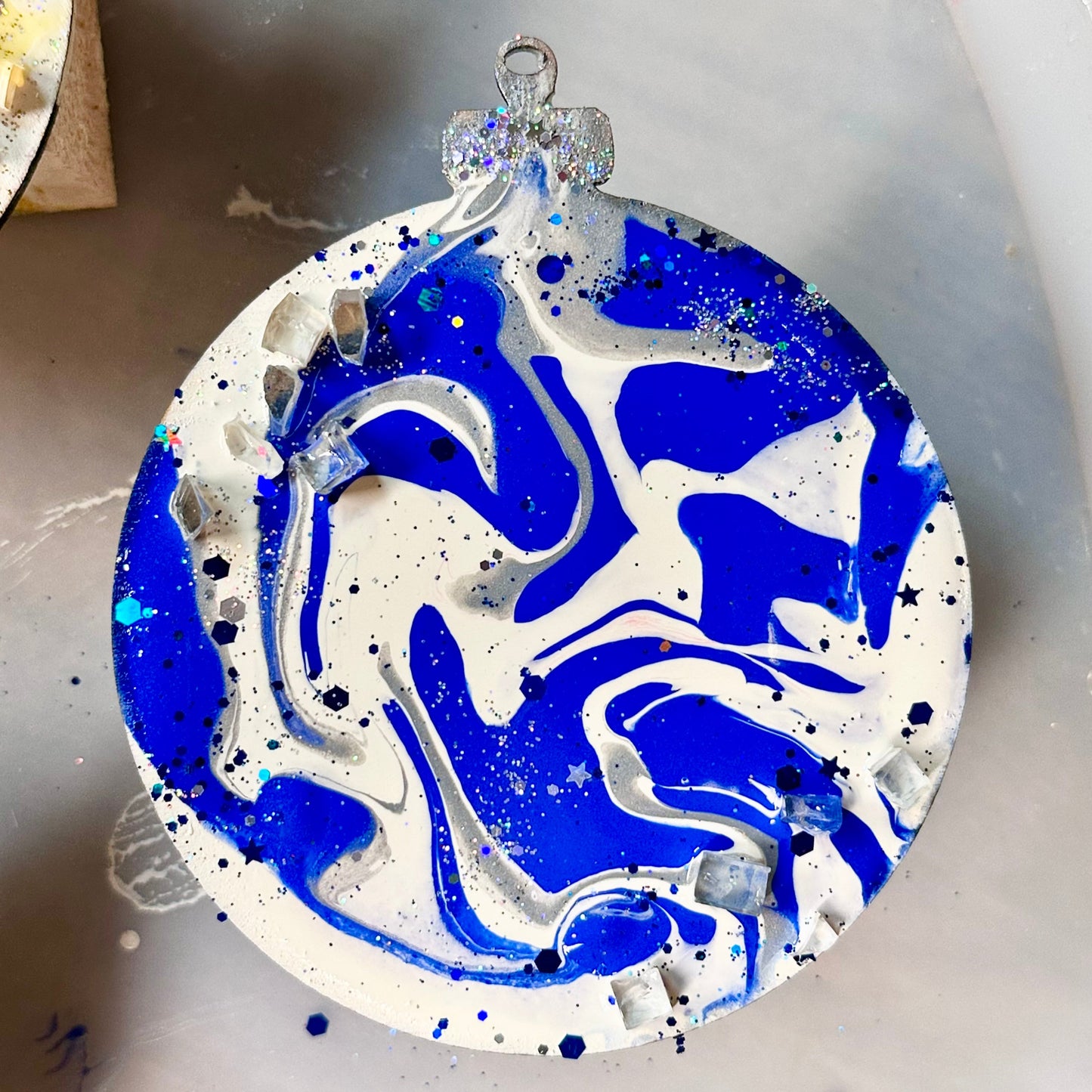 Decorative ornament with blue and white abstract design on a white surface
