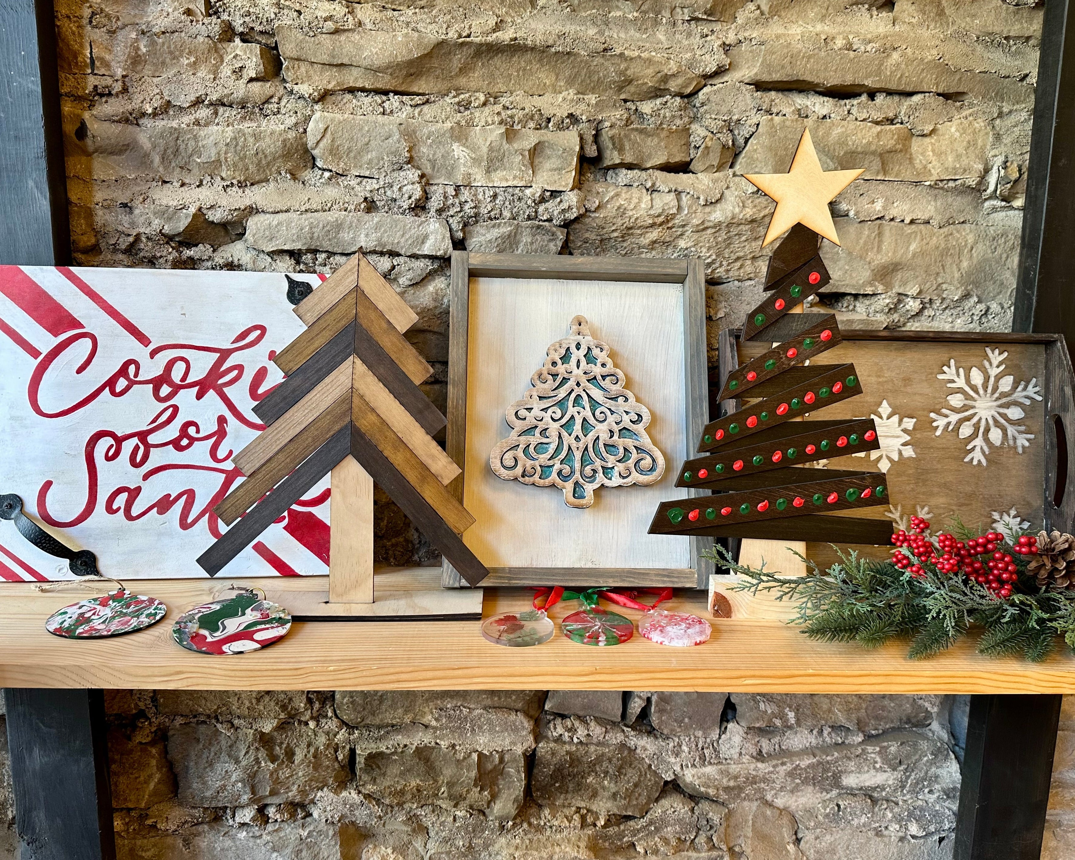 Decorative Christmas projects on a shelf against a stone wall
