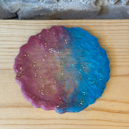 Colorful epoxy coaster on a wooden surface