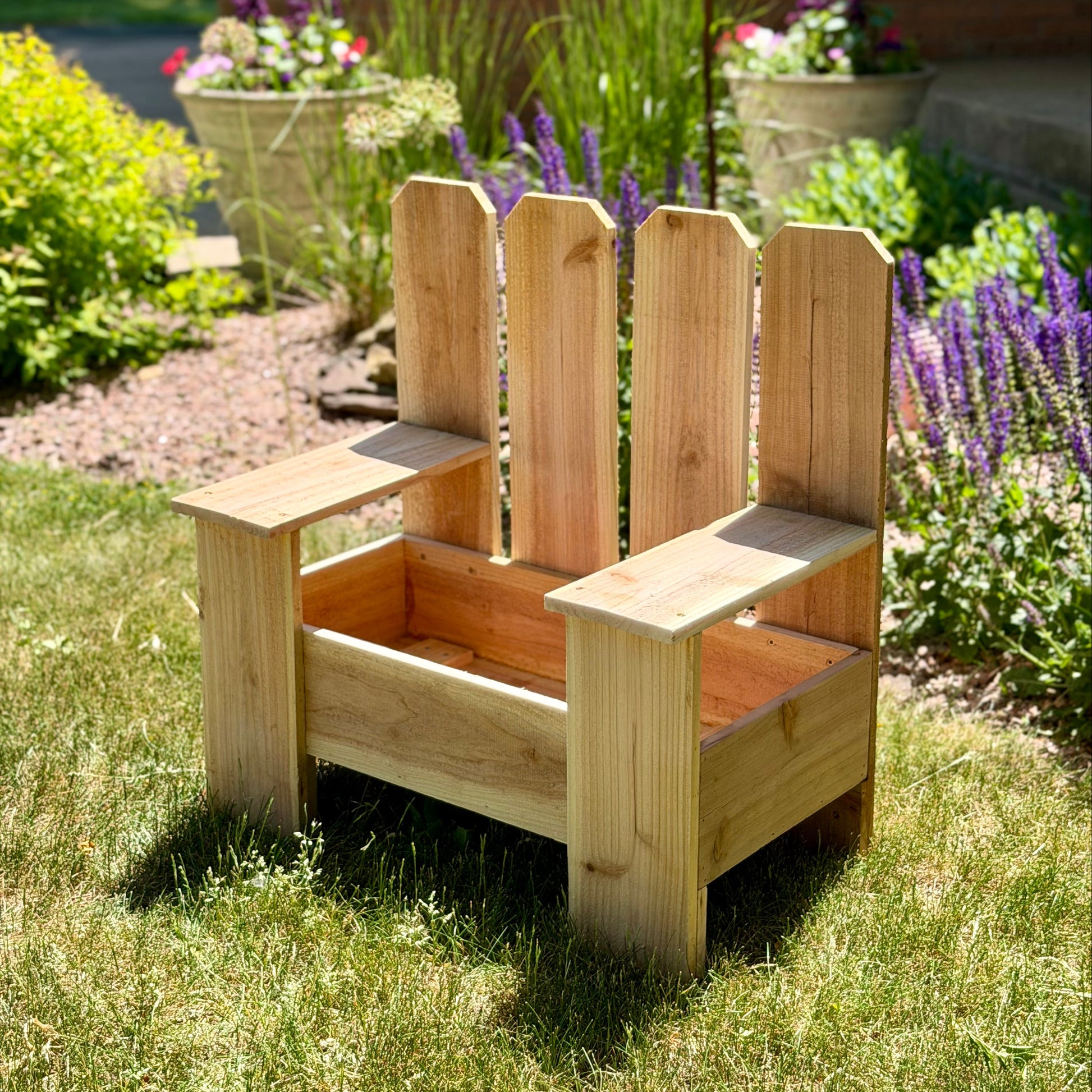 Wooden planter chair in a garden setting with flowers and plants.