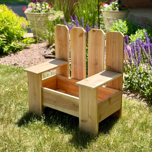 Wooden planter chair in a garden setting with flowers and plants.