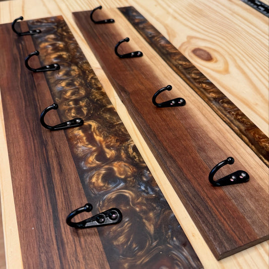 Epoxy River wall-mounted rack with multiple hooks on a wooden surface.