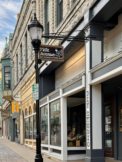 Street view of a building with 'Fisk Avenue DIY Studio & Wine Bar' sign on a clear day.