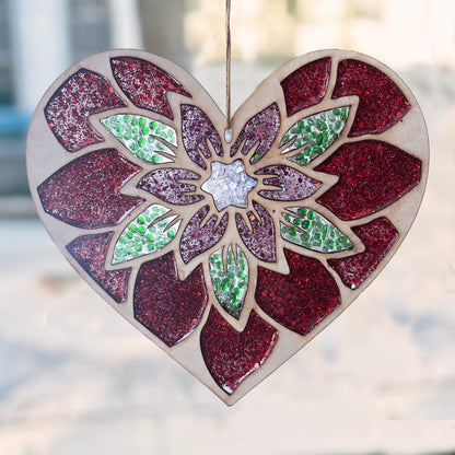 Heart-shaped suncatcher with a floral design and glittery finish, hanging against a blurred street scene.