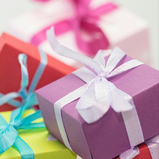 Colorful gift boxes with ribbons on a light background