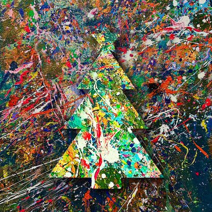 Wooden cutout of a splatter painted Christmas tree on a colorful wall.